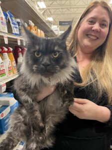 A woman holding a cat in her arms.