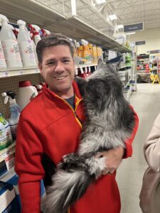 A man holding a cat in his arms.