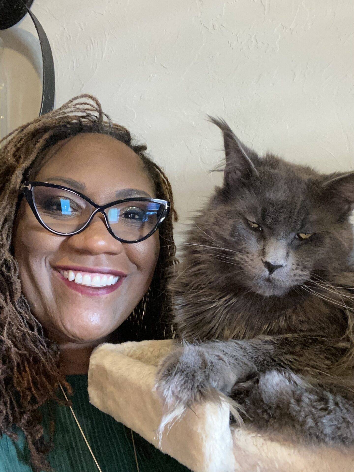 A woman with glasses and a cat