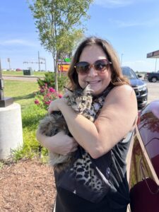 A woman holding a cat in her arms.