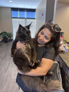 A woman holding a cat in her arms.