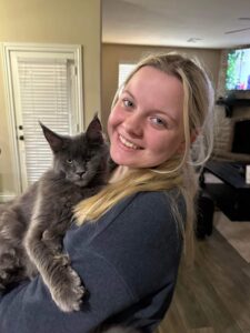 A woman holding a cat in her arms.