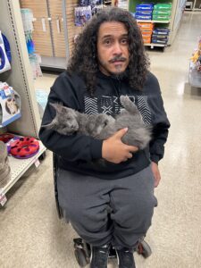 A man holding a cat in his arms.