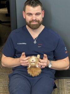 A man holding a cat in his hands.